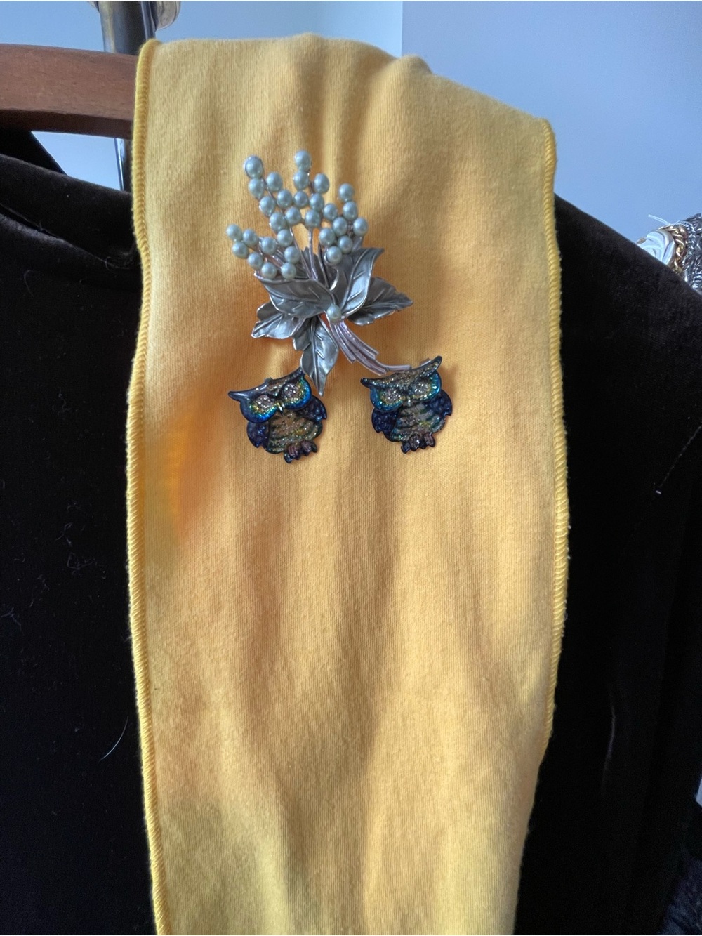 Yellow Scarf with Decorative Owl Pins and floral spray pin.